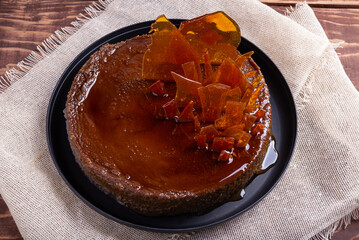 Delicious Homemade Caramel Flan with Toffee Decoration on Black Plate