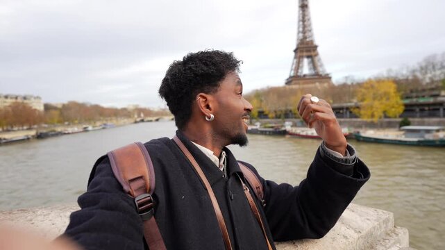 Influencer live streaming his parisian vacation with eiffel tower view