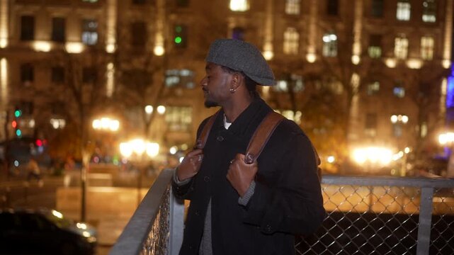 Young black tourist admiring paris cityscape at night