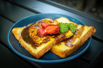 Sweet French Toast with Strawberry and Mint on Dark Blue Plate