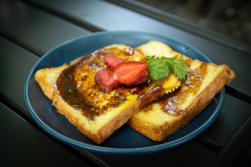 Sweet French Toast with Strawberry and Mint on Dark Blue Plate