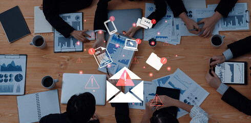 A dynamic business meeting showcasing a team analyzing data and discussing strategies with technology tools on a modern office desk, emphasizing teamwork and interaction. Gantry