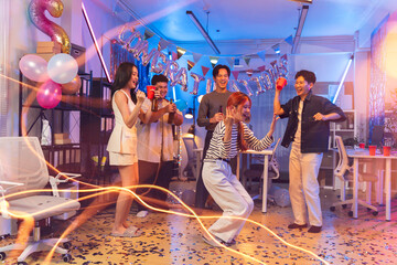 Excited Asian colleagues celebrating an "congratulation" achievement and Happy New Year 2026 in a office party,holding golden foil balloons Number 1.Concept of team celebration and holiday party