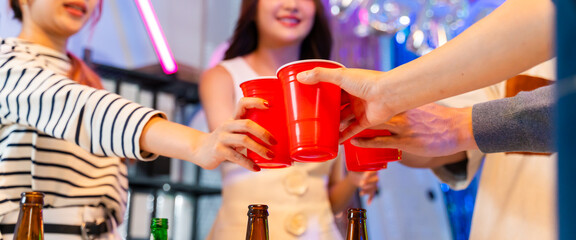 Excited Asian colleagues celebrating an "congratulation" achievement and Happy New Year 2026 in a office party,holding golden foil balloons Number 1.Concept of team celebration and holiday party