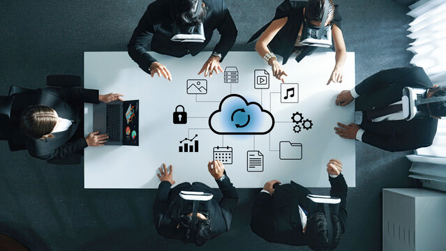 A group of business professionals engage in a collaborative meeting using virtual reality technology in a modern office setting, focusing on innovative solutions. Gantry - Powered by Adobe