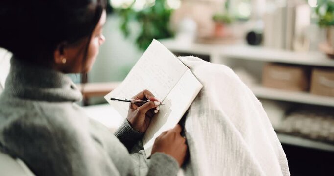 Hands, inspiration and writing with woman on sofa in living room of home for reflection or memories. Journaling, notebook and thinking with person in apartment for agenda, personal growth or planning