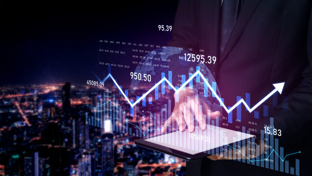 A businessman using a tablet displays financial data and stock market graphs, set against a vibrant city skyline at night, showcasing modern technology and growth. Scalp - Powered by Adobe