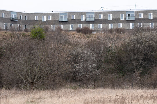 Copenhagen urban landscape showing modern architecture integrated with nature, vegetation and green design in an outdoor environment framed by residential rows and wide open terrain