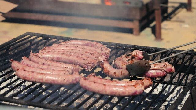 Juicy beef sausages grilled on the grill, summer picnic concept.