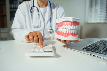 dentists with calculate medical fee costs & revenue. practitioner use calculator at clinic.