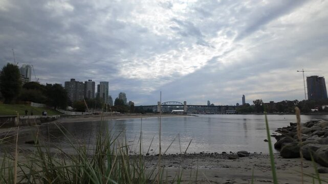 Gimbal wide panning shot of English Bay Beach on a cloudy day in Vancouver, British Columbia, Canada. 4K at 30 FPS
