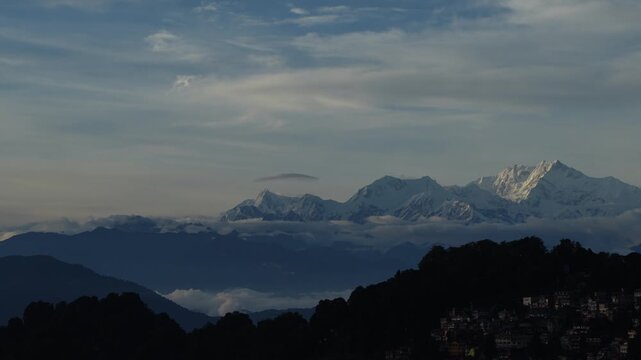 The first morning light of the sun has arrived on the distant horizon of Mount Kanchenjunga.