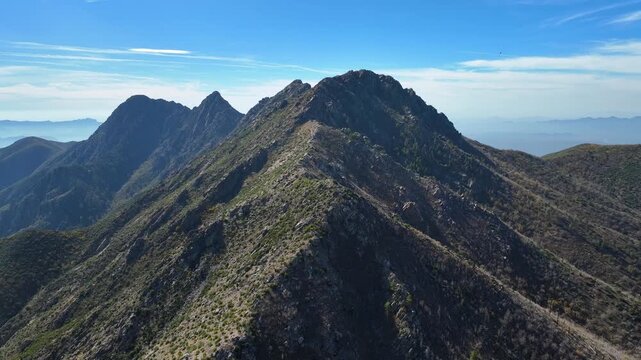 Aerial view of the rugged Four Peaks Wilderness, showcasing the stark beauty of the mountains against the clear blue sky, Apache Junction, Arizona, United States.