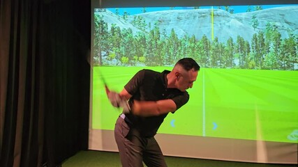Golf swing practice in indoor simulator with realistic landscape and detailed graphics