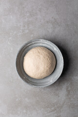 Overhead view of scallion pancake dough resting in a bowl, top view of cong you bing dough resting, process of making scallion pancakes