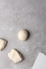 Overhead view of divided chinese scallion pancake dough, top view of chinese pancake dough, process of making cong you bing