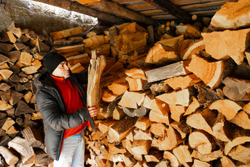 Man holding firewood piece ready for winter heating