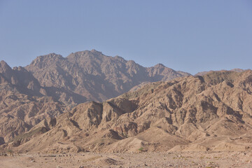 Rocky desert mountains under clear blue sky
