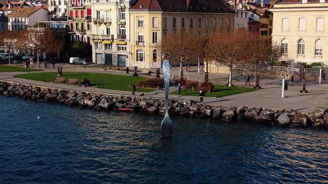 Aerial view of The Fork of Vevey plunges into the lake, reflecting the buildings and trees on Quai Perdonnet, Vaud, Switzerland.