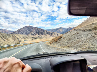 Scenic mountain drive with winding road and vibrant sky in a remote landscape