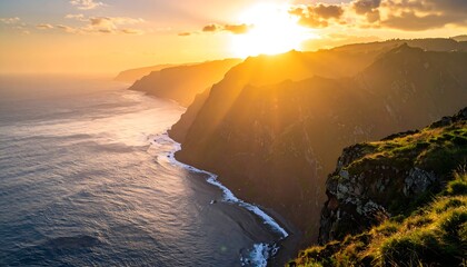 Scenic ocean coastline with towering cliffs at sunset, the light streaming through mountain peaks