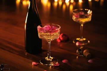 A romantic setting with champagne glasses, pink rose petals, and warm golden lights, evoking love and celebration.