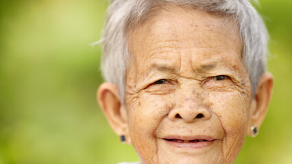 close up portrait of old filipino woman smiling looking at camera, grey hair, missing teeth, wrinkles, philippines, asia, happy asian senior people