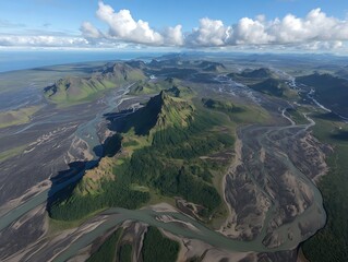 Aerial view of a mountainous region, rivers winding through valleys under a bright blue sky