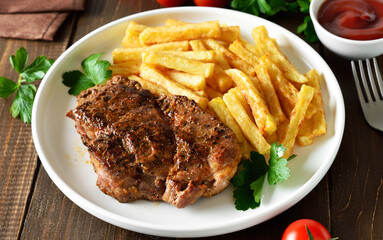 Roasted pork steaks and french fries
