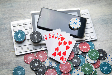 Poker chips and cards with a computer keyboard. Online casino. Gambling