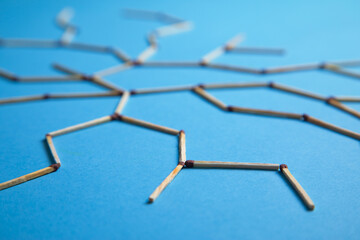 Global network connection made by match on the blue background.