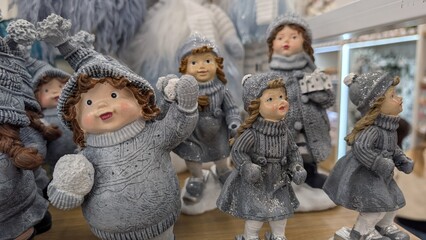 Vibrant Knitted Figures With Facial Artwork Showcased In Reflective Surroundings Within Retail...