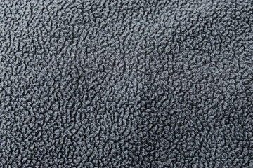 A dark gray fleece fabric with a soft, fuzzy surface. The dense, repeating fiber pattern creates a warm, cozy look. © Hendri