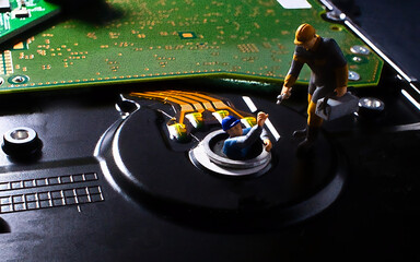 Data maintenance operations, miniature technical service in hard drive miniature workers repairing a damaged hard drive data system