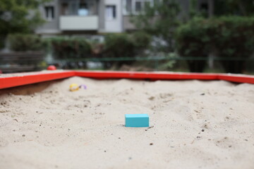 Sandbox with various outdoor toys. Sandbox for children's games. Summer concept.
