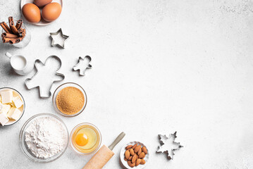 Christmas baking background with baking ingredients and cookie cutters