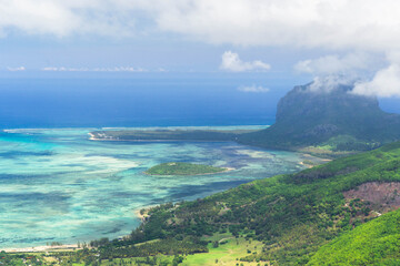 Aerial view of lagoon, coral reefs and the iconic Le Morne Brabant mountain on the southwest coast of Mauritius, Indian Ocean