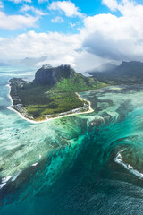 Vertical aerial view of Le Morne Brabant with lagoon colors and underwater waterfall effect, Mauritius, Indian Ocean