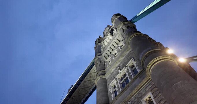 Descending nadir view of one of the Tower Bridge turrets over the River Thames at sunset, capturing London&rsquo;s skyline, warm evening light, and iconic historic engineering.