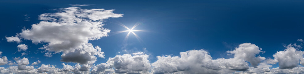 Seamless hdri panorama 360 degrees angle view blue sky with beautiful fluffy cumulus clouds with zenith for use in 3d graphics or game development as sky dome or edit drone shot