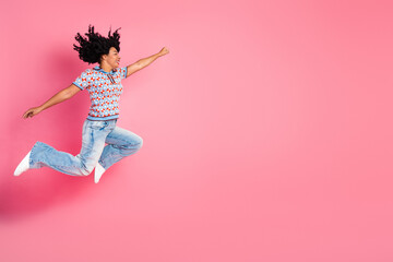 Girl in colorful shirt leaps against pink background expressing joy energy and fashion style for lifestyle advertising campaigns