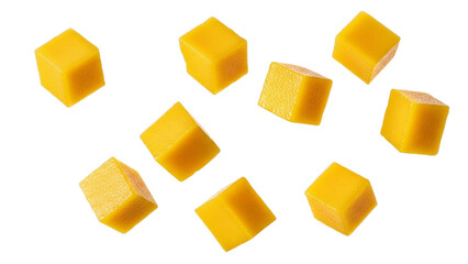 Eight bright yellow mango cubes scattered against a white background with abstract yellow and