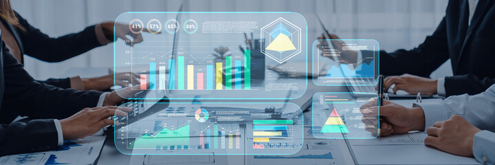 A group of professionals engaged in a modern business meeting, utilizing digital dashboards and data visualizations on laptops to enhance collaboration and decision-making. Trope