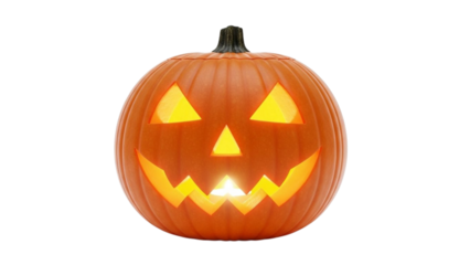 Orange carved Halloween pumpkin with glowing yellow light inside jack o lantern