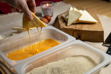 Bread the cheese with eggs and breadcrumbs