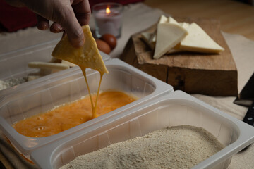Bread the cheese with eggs and breadcrumbs