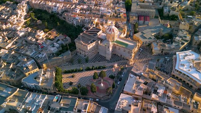 Aerial 4K view of St. Paul's Basilica and main square in Rabat, geometric stone pavement patterns and historic dome near Mdina, Malta travel, drone