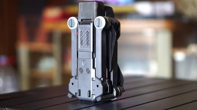 Foldable drone standing in an upright position, showcasing compact and portable design for easy travel.