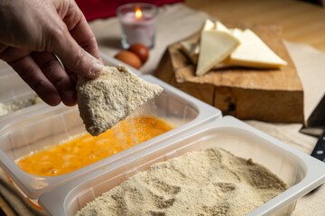Bread the cheese with eggs and breadcrumbs