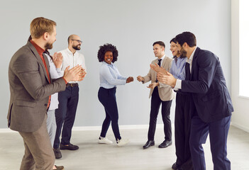 Group of happy excited business young people men and women having fun in office happy to make a...